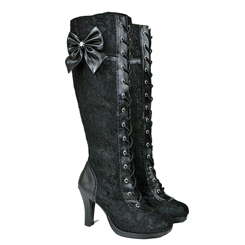 Black lace steampunk knee-high boots with rhinestone bow accent, right three-quarter view highlighting lace trim and block heel construction