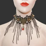 Steampunk gothic lace choker necklace front view with black floral lace, red heart pendant, bronze gears and beaded tassels on mannequin