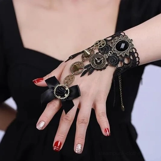 Steampunk lace hand jewelry with dangling chain, gear decorations and black gem accent on side profile, vintage-inspired hand cuff on female model