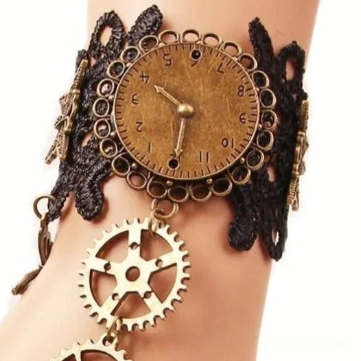 Black steampunk lace wrist cuff gloves with hollow floral lace design, vintage bronze clock dial, and hanging gear pendants, close-up front view on female arm