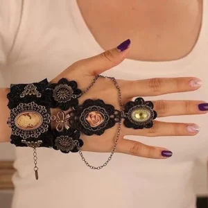 Black lace steampunk slave bracelet with bronze cameo and chain ring detail, overhead view on model with purple nail polish