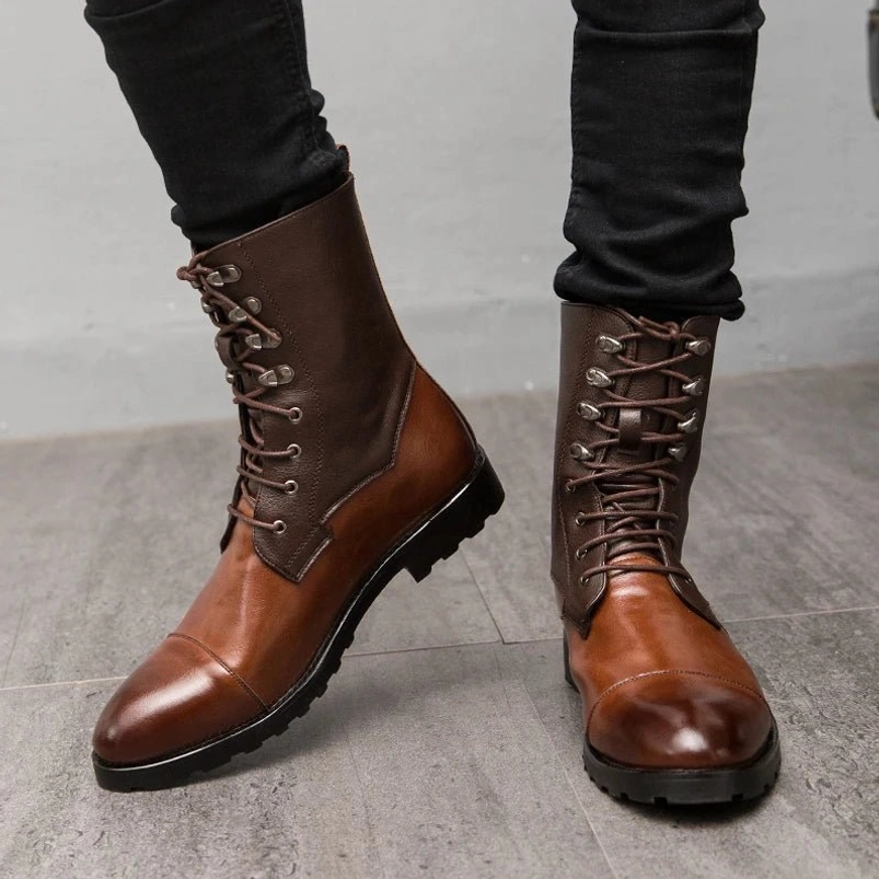Steampunk combat boots front direct view with male model wearing black skinny jeans, highlighting polished cap toe detail, two-tone brown leather upper, industrial-grade metal eyelets, and authentic lace-up fastening system