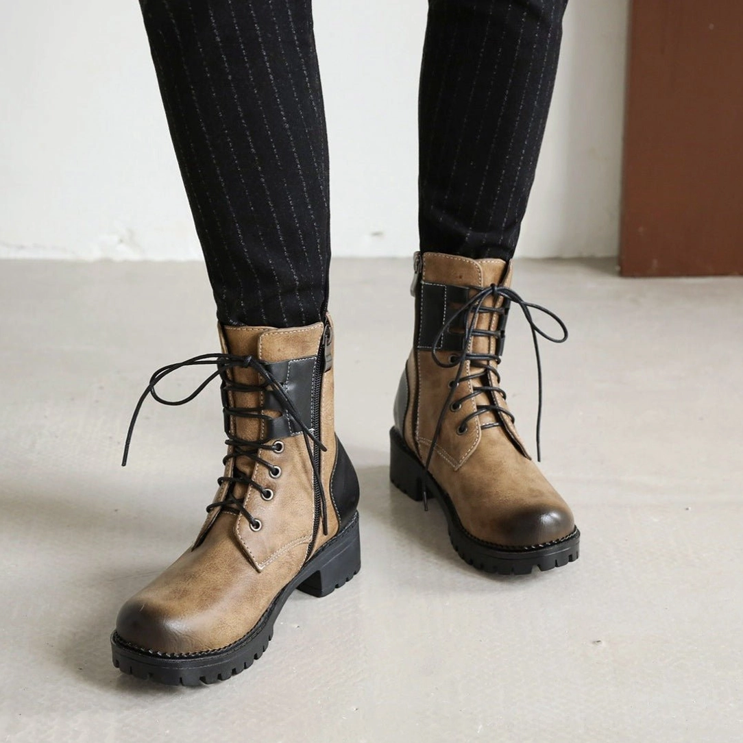 Women's steampunk lace-up boots three-quarter front angle - vintage brown finish with black accent panels, reinforced lacing, industrial rubber tread pattern