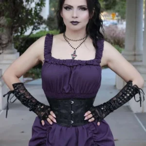 Goth model wearing black steampunk lace-up long gloves with metal eyelets paired with purple goth dress and corset outdoors