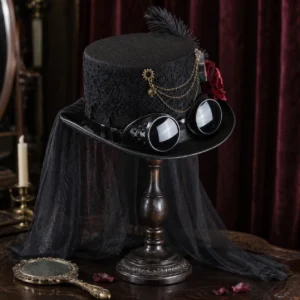 Steampunk lady hat side view showing black lace fabric, attached black veil, red velvet rose, and mechanical goggles detail on wooden vanity stand