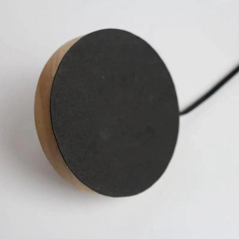 Steampunk lamp base bottom view showing natural wood edge black anti-slip rubber pads and power cable side close-up