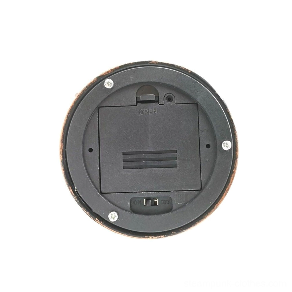 Battery compartment detail of steampunk lamp showing black plastic battery box with bronze metal rim, overhead view