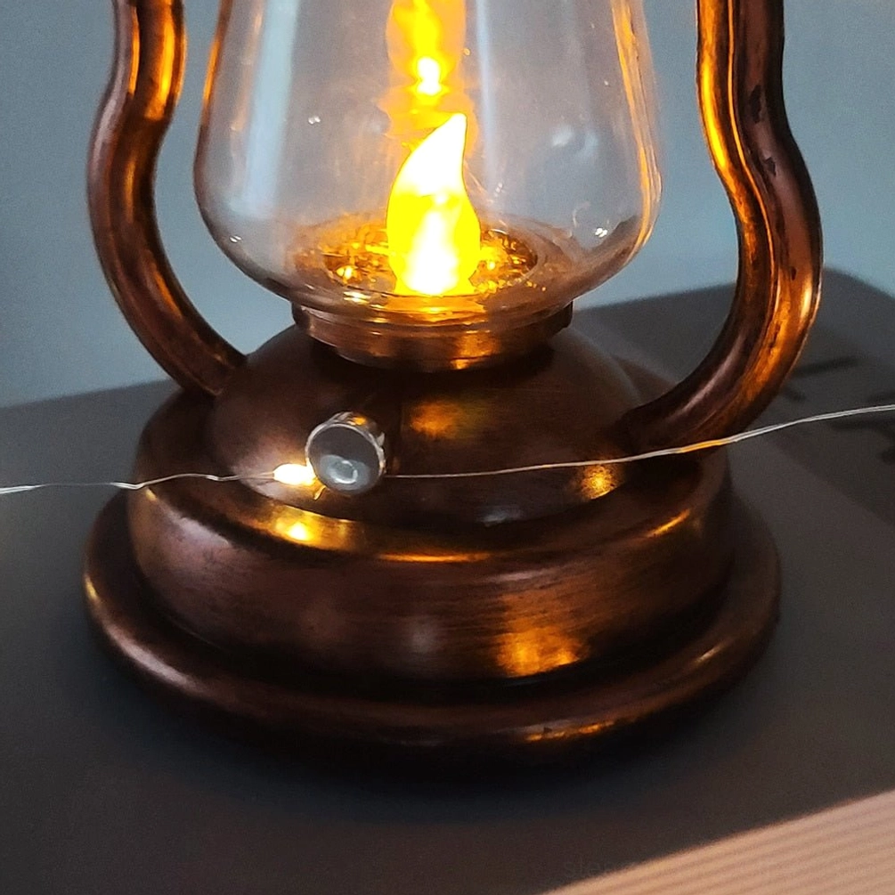 Close-up macro view of flickering LED flame insert inside copper bronze steampunk kerosene lantern with glass shade