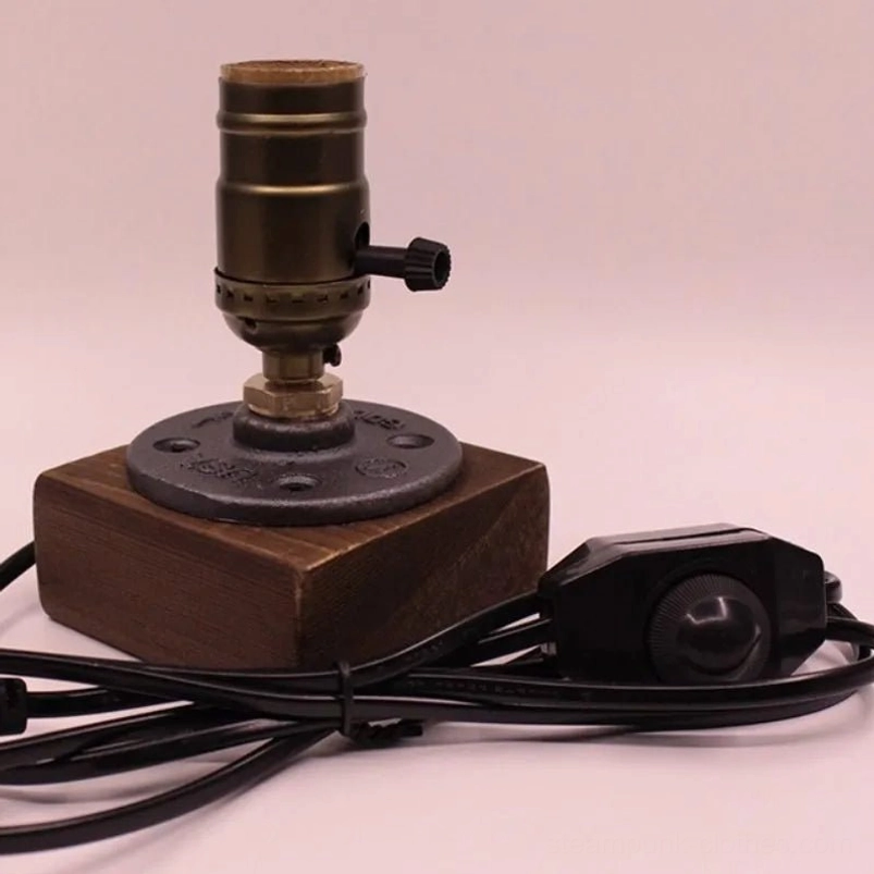 Close-up of steampunk lamp E27 socket with cast iron-style bulb holder, inline rotary dimmer control, and vintage fixture assembly