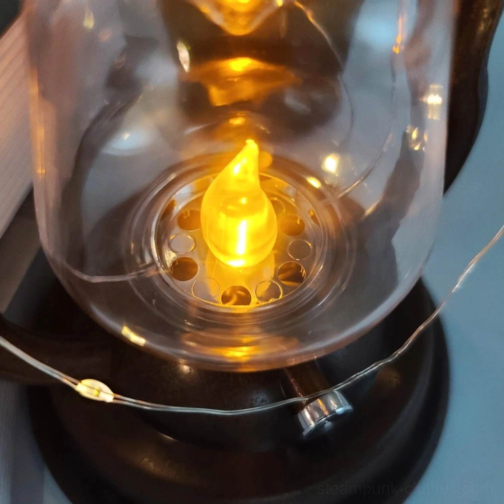 LED flame insert macro photography showing simulated flickering flame effect inside clear glass steampunk lantern