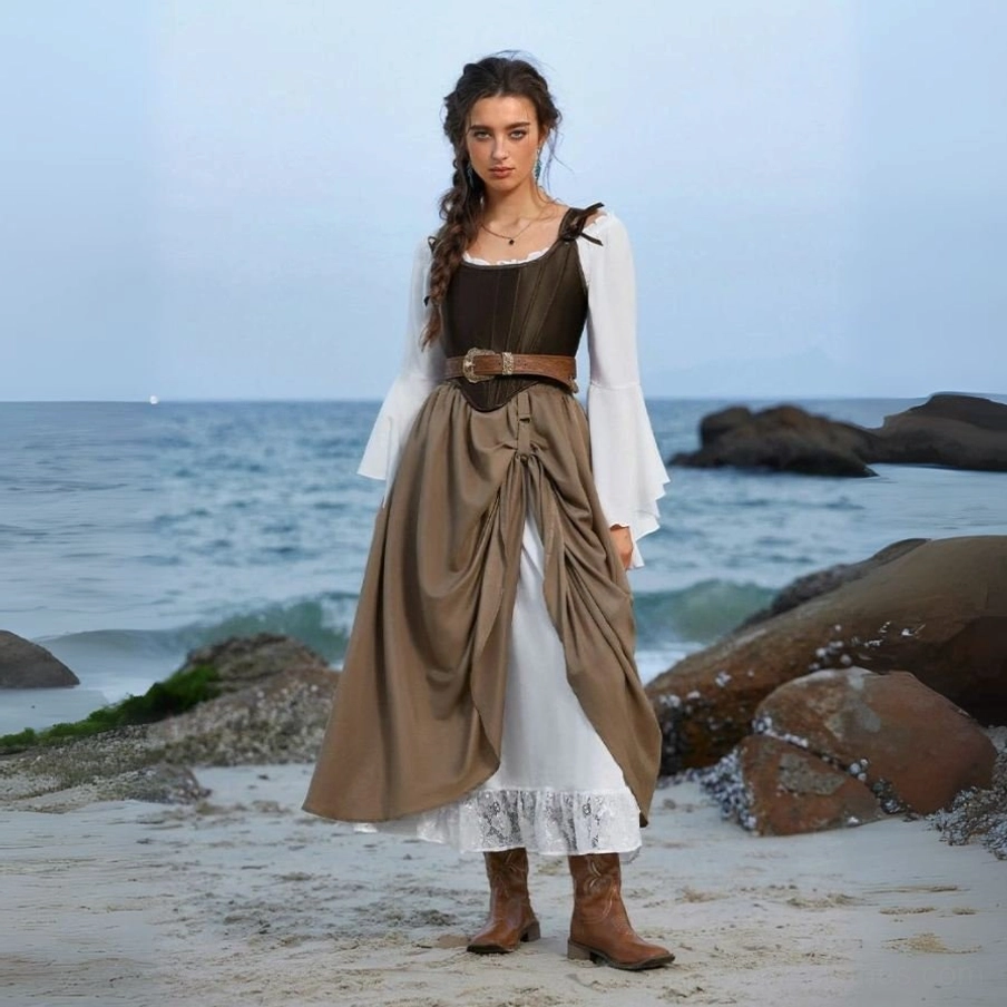 High-waisted steampunk layered skirt with draped Victorian design, white lace-trimmed underdress, worn by female model in coastal beach setting, full-body front view