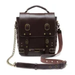 Steampunk leather crossbody bag front three-quarter view with brass hardware, crisscross lace-up side panels, and adjustable leather strap showing authentic Victorian-industrial design