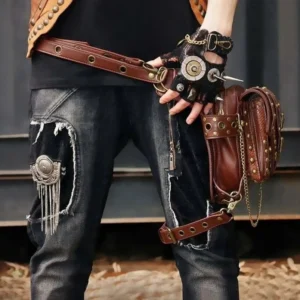 Steampunk convertible thigh leg holster bag on full-body male model in outdoor urban setting, displaying studded leather jeans and complete steampunk accessories ensemble with goggles