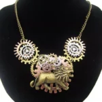 Steampunk lion necklace with aged bronze gears - front view on black velvet bust display showing detailed pendant with 3D lion motif surrounded by mechanical cogs