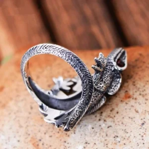 Wrap-around silver lizard steampunk ring overhead view showing reptile scale patterns, vintage finish, and glowing red gemstone eye