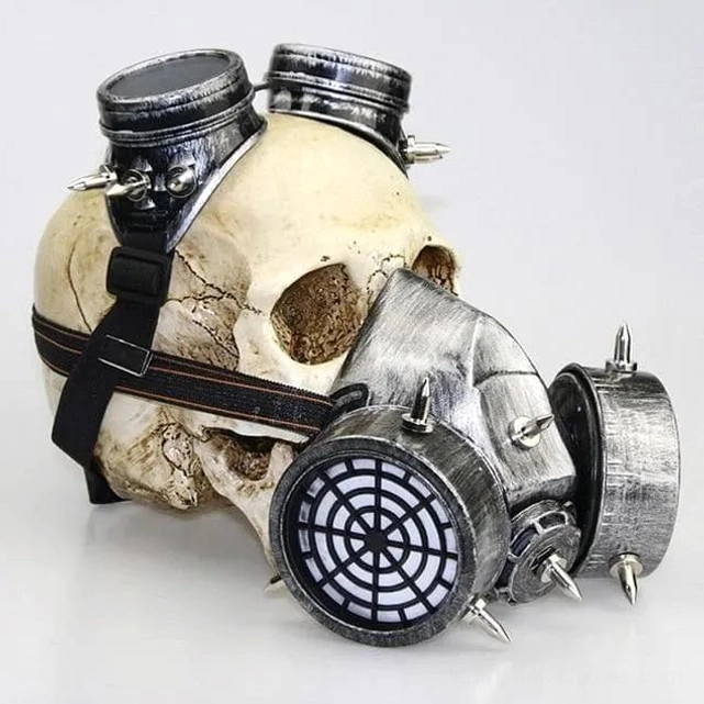 Steampunk spiked gas mask left three-quarter view - silver weathered metal with grid-style air filter and adjustable leather strap