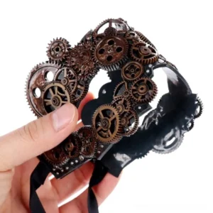 Black PVC steampunk masquerade mask held in hand, showing side profile with riveted base and decorative gear ornaments