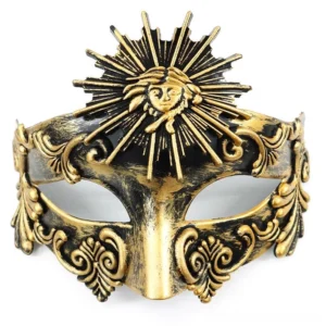 Steampunk masquerade face mask with aged gold-black finish featuring intricate sun god relief ornament and vintage scroll carvings, front flat view on white background