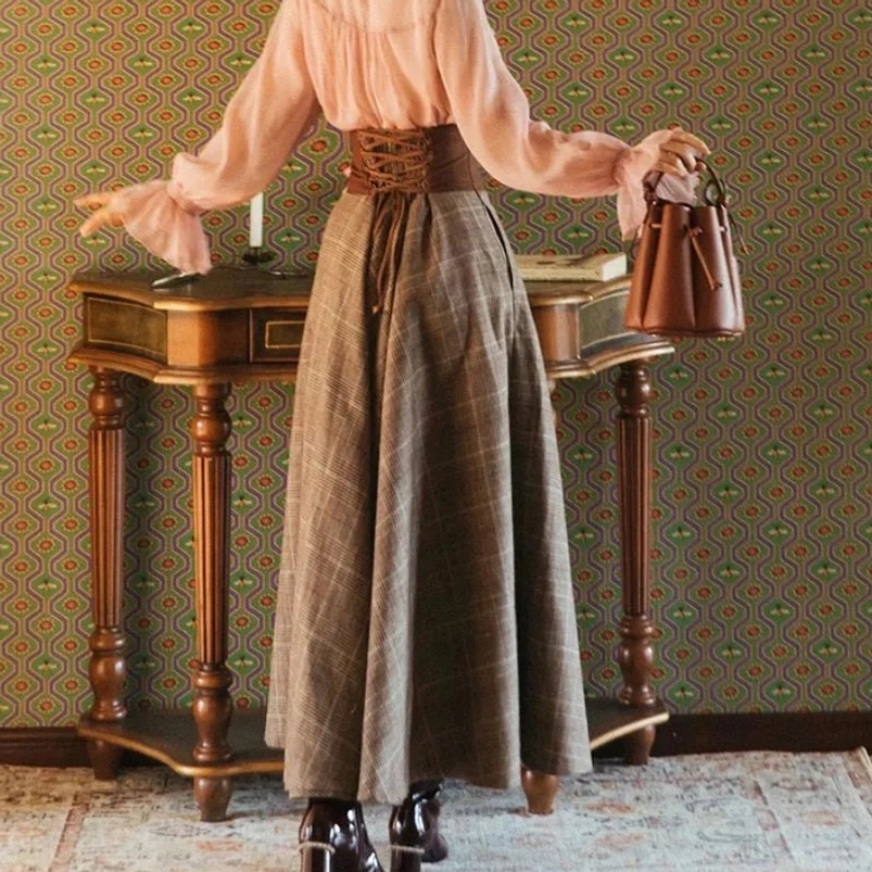 Brown glen plaid steampunk skirt back view showing waist sash detail and flowy floor-length silhouette