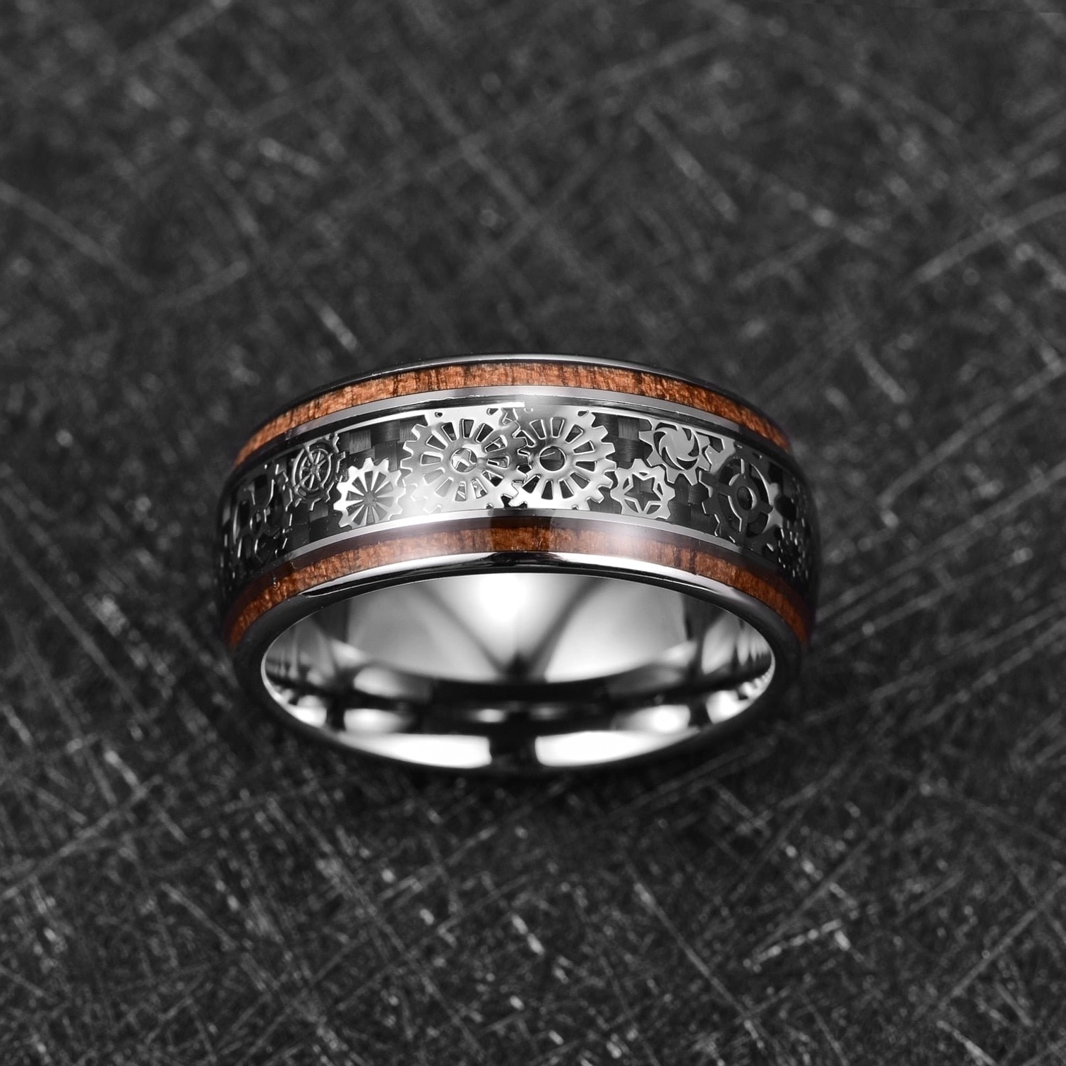 Top-front view of men's steampunk gear band ring showing full-face gear engravings and wood inlay craftsmanship on tungsten carbide