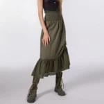 Army green steampunk midi skirt with smocked waistband worn by model from front three-quarter angle, showing side drawstring ruching detail and ruffled lace hem