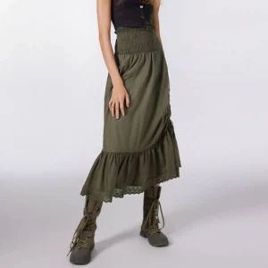 Army green steampunk midi skirt with smocked waistband worn by model from front three-quarter angle, showing side drawstring ruching detail and ruffled lace hem