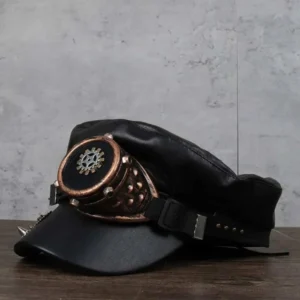 Steampunk military captain cap left side profile highlighting studded bronze goggle assembly, ornamental gear emblem on strap, and side-mounted brass trinket details