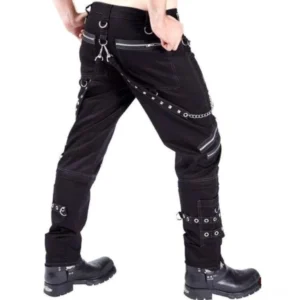 Steampunk military pants rear three-quarter view showing D-ring waist straps, thigh zippers, ankle grommet cuffs, and chain accents