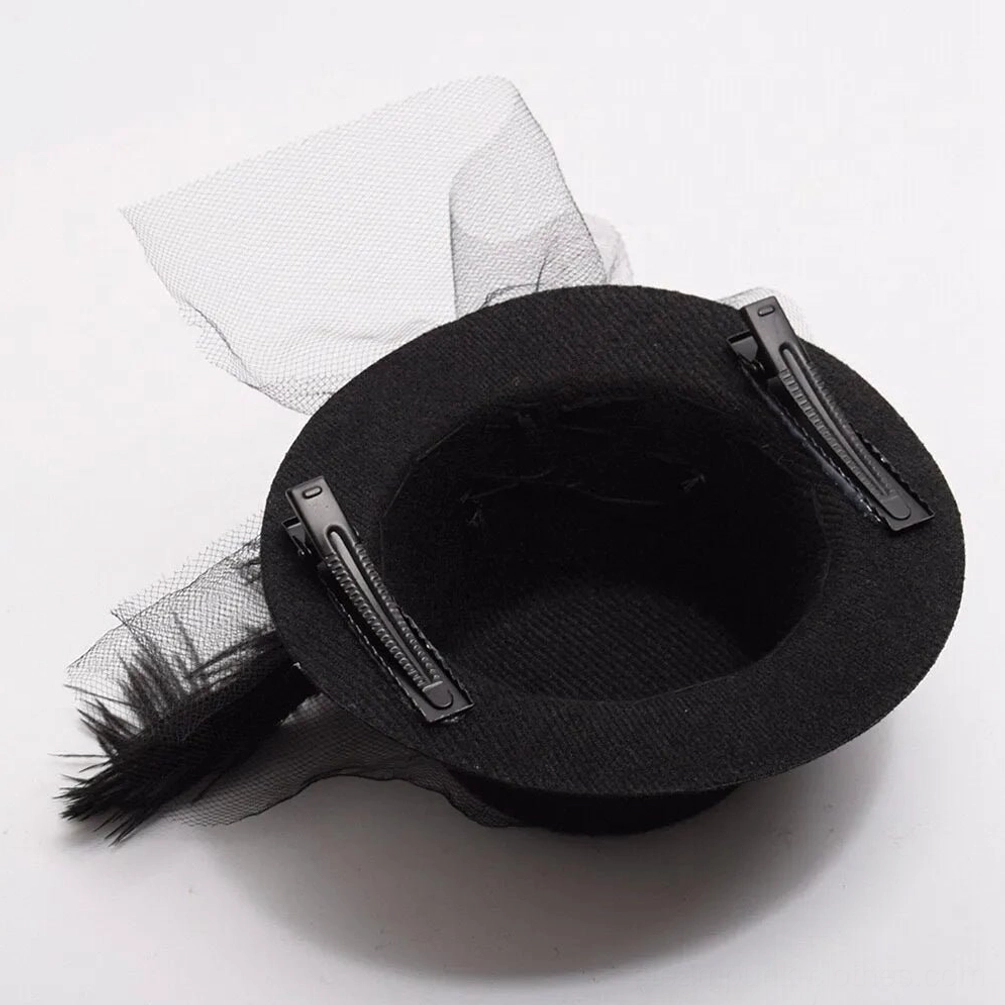 Back bottom view of steampunk mini fascinator showing hair clip attachment mechanism with feather and tulle decoration