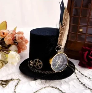 Steampunk mini top hat with compass and feather decoration displayed in overhead three-quarter view on vintage wooden surface with floral backdrop