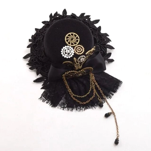 Steampunk mini top hat flat lay front view featuring black lace trim, mixed metal gear ornaments, decorative bow and chain tassel detail