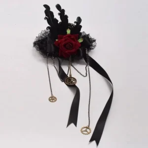 Flat lay overhead view of steampunk mini top hat featuring black lace trim, dark feathers, burgundy rose, metal gear charms and long black satin ribbons