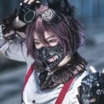Steampunk leather mouth mask with bronze metal gears and adjustable straps - front close-up view worn by cosplayer with purple hair at anime convention