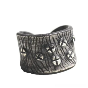 Adjustable steampunk nail ring with aged silver finish and cross screw ornaments, front three-quarter view on white background