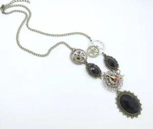 Steampunk vintage necklace side flat lay displaying antique bronze chain detail, clockwork mechanisms, and black oval gemstone settings on white background