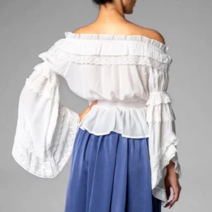 Back view of white chiffon ruffle off-shoulder blouse on model, displaying cascading ruffles and lace trims from behind, flared sleeves and structured smocked waist - Victorian steampunk shirt
