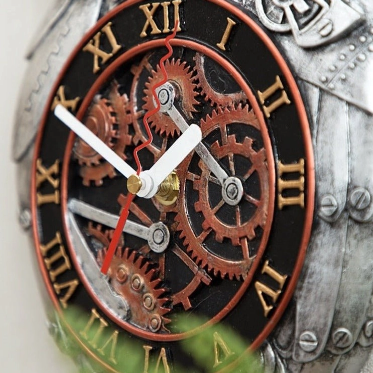 Close-up detail of steampunk owl clock dial showing black face with gold Roman numerals and copper exposed gears integrated into owl torso design