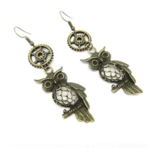 Steampunk owl dangle earrings with bronze metal, hollow-carved design, and gear charm details on white background