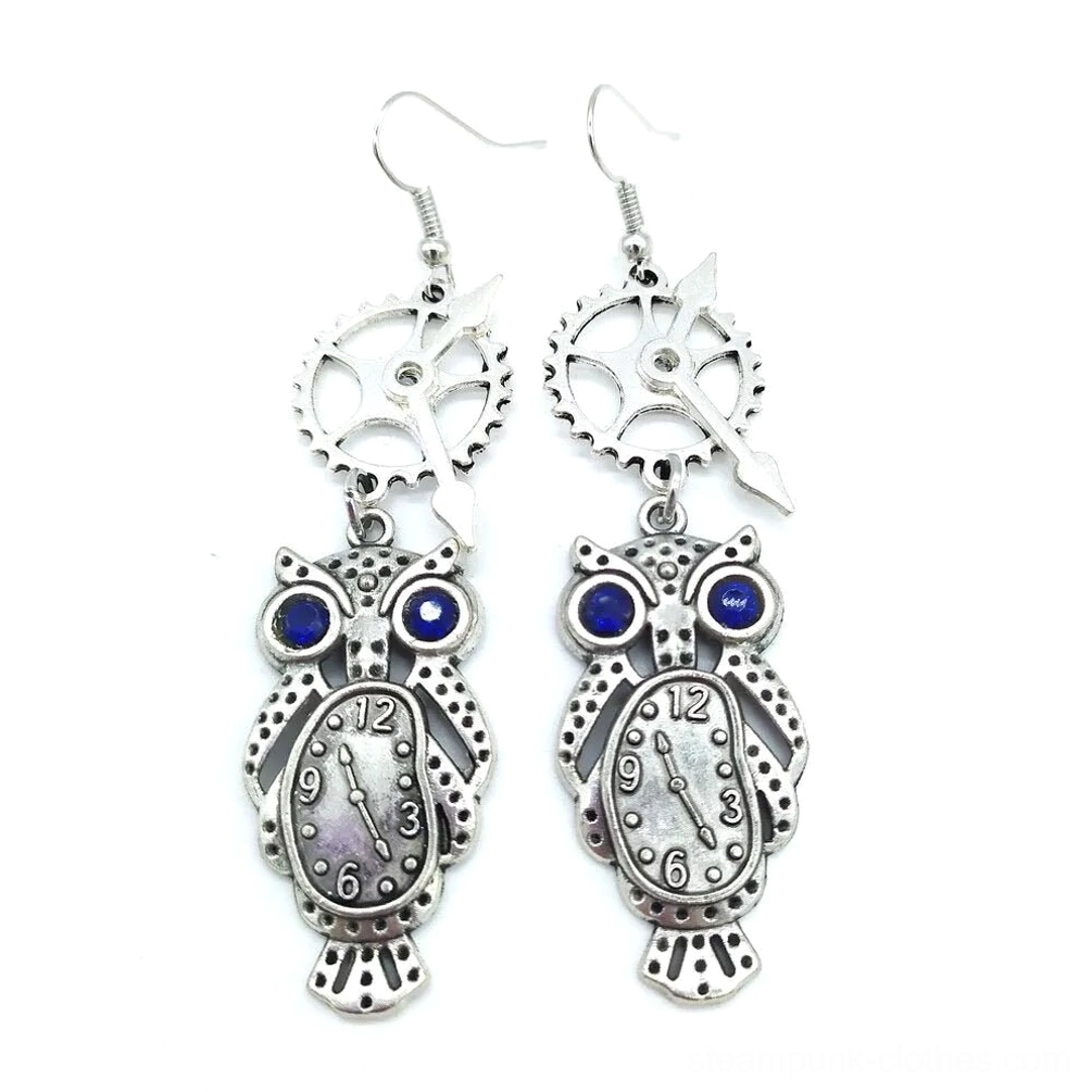 Steampunk owl dangle earrings with antique silver finish, blue rhinestone eyes, and clock dial mechanism - flat lay frontal view on white background