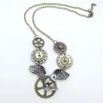 Steampunk flying owl necklace overhead flat lay featuring mixed vintage metal gears, bronze chain with extender clasp on white background