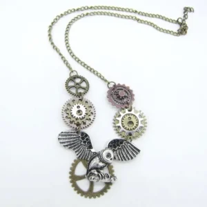 Steampunk flying owl necklace overhead flat lay featuring mixed vintage metal gears, bronze chain with extender clasp on white background