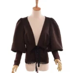 Steampunk palace blouse front view - dark brown suedette with deep V-neck, dramatic puff sleeves, and black lace hem detail