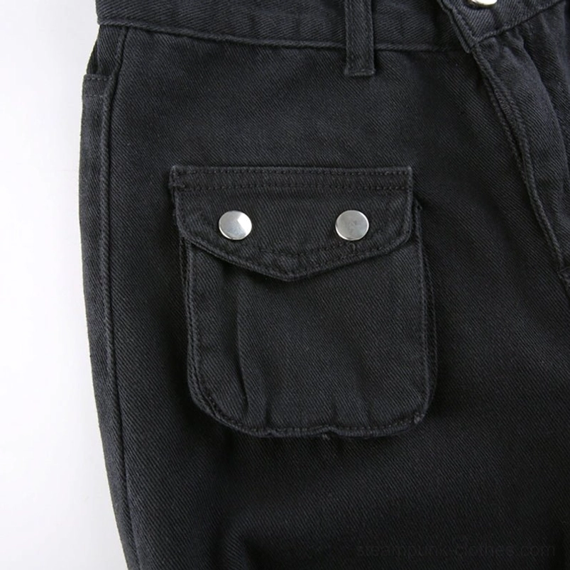 Close-up detail of steampunk cargo pants pocket featuring black twill fabric with flap closure and two silver snap buttons