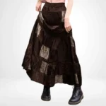 Steampunk patchwork maxi skirt front view with dark brown velvet and paisley print patches, tiered ruffled hem, modeled by female in studio setting