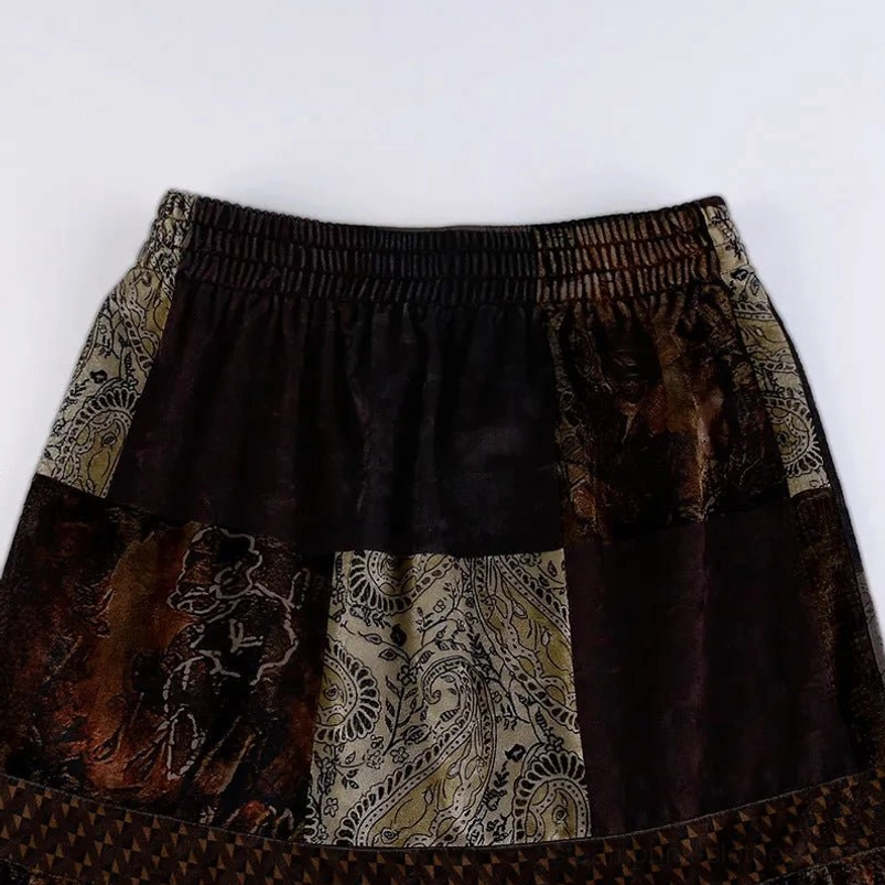 Flat lay top-down view of steampunk patchwork skirt elastic waistband showing patchwork velvet construction and waist band detail