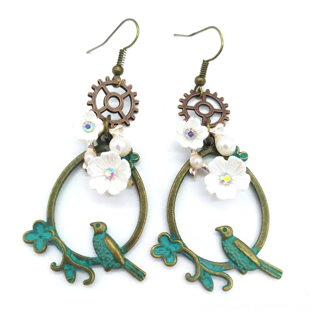 White flower steampunk loop earrings showcasing verdigris bronze metal, gear charm top, small white flowers, pearl beads, and bird embellishment