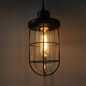 Industrial steampunk pendant lamp with black metal frame, protective wire cage, and illuminated Edison bulb against dark background, showcasing authentic Victorian-era design aesthetic