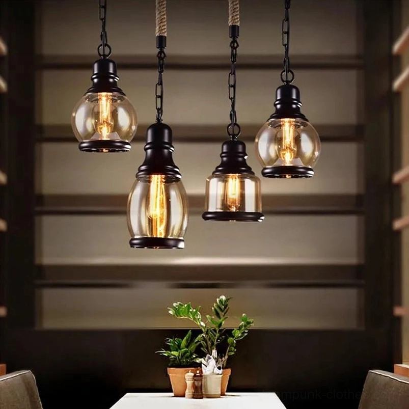 Multiple vintage industrial steampunk pendant lights in restaurant setting, amber glass shades with matte black fixtures, Edison bulbs