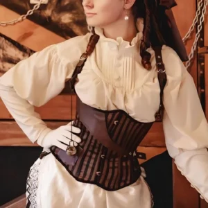 Steampunk pirate corset with brown-black striped fabric and leather trims on Caucasian female model, front left half-body view in vintage indoor pirate setting