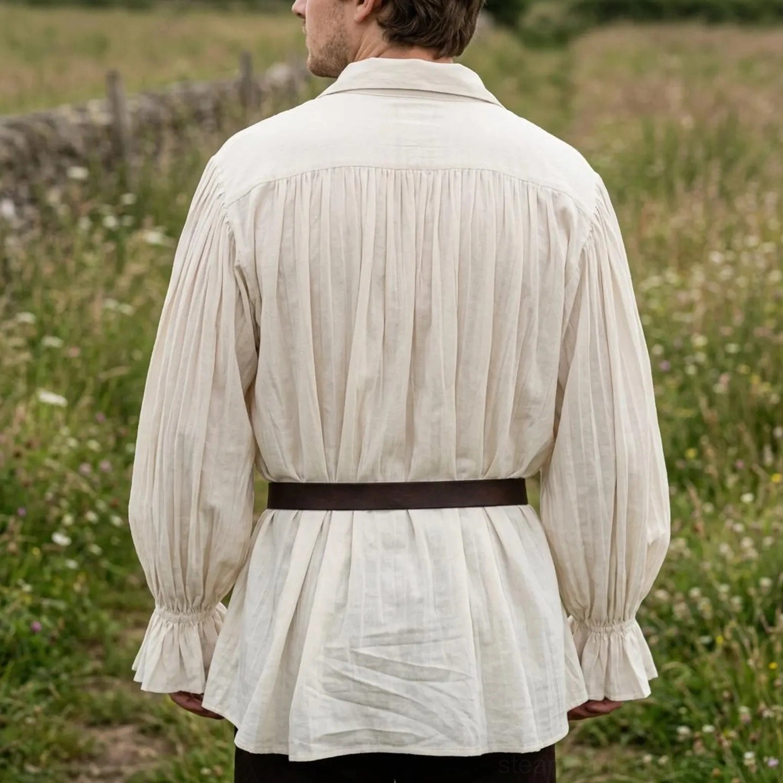 Back view of steampunk pirate shirt showing pleated detailing and bell sleeves, beige linen construction with black waist belt worn outdoors